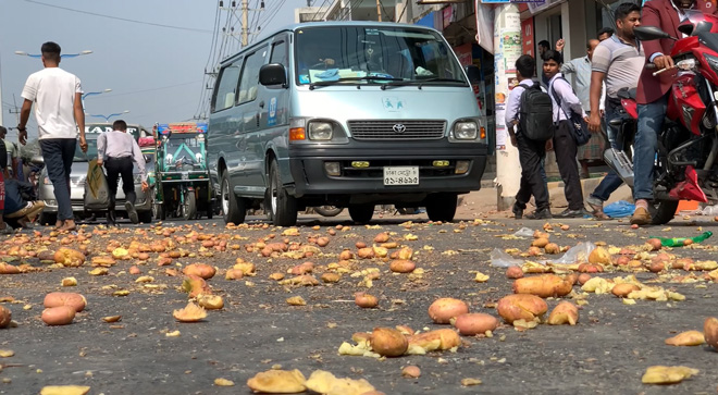 "Farmers in Rajshahi stage a protest against the hike in potato storage fees by dumping eight sacks of potatoes on the Rajshahi-Nogoa highway and rolling in protest in front of the Government Cold Storage in Baya area, Paba Upazila."